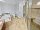 Large bathroom with soaking tub, walk-in shower, and granite vanity at 114 Canterfield Rd, Cary, NC 27513