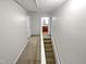 Upstairs hallway with carpeted floor and access to bathroom and bedrooms at 114 Canterfield Rd, Cary, NC 27513