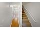 Bright hallway with hardwood floors and staircase at 114 Canterfield Rd, Cary, NC 27513