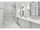 Luxurious bathroom with double vanity, marble floors, and glass shower at 620 Wade Ave # 301, Raleigh, NC 27605