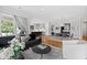 Open concept living room with hardwood floors, black leather sofa and large windows at 620 Wade Ave # 301, Raleigh, NC 27605