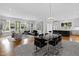 Open concept living and dining area with hardwood floors, modern furniture, and chandelier at 620 Wade Ave # 301, Raleigh, NC 27605
