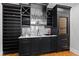 Modern wet bar with extensive cabinetry and wine storage at 620 Wade Ave # 301, Raleigh, NC 27605