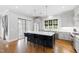 Modern kitchen with island, stainless steel appliances, and hardwood floors at 620 Wade Ave # 301, Raleigh, NC 27605