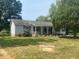 Ranch-style home with covered porch and landscaped yard at 910 Vanco Mill Rd, Henderson, NC 27537