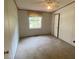 Spacious bedroom with neutral carpeting and window at 910 Vanco Mill Rd, Henderson, NC 27537