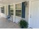 Covered front porch with seating and a view of the yard at 910 Vanco Mill Rd, Henderson, NC 27537