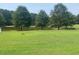 Spacious backyard with pond and lush green grass at 910 Vanco Mill Rd, Henderson, NC 27537