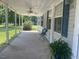 Covered front porch with seating and a view of the yard at 910 Vanco Mill Rd, Henderson, NC 27537