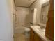 Bathroom with tub, toilet and wood vanity at 910 Vanco Mill Rd, Henderson, NC 27537