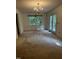 Bright dining room with chandelier, carpet, and access to deck at 492 Beechmast, Pittsboro, NC 27312