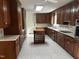 Kitchen with island, wood cabinets, and tile flooring at 492 Beechmast, Pittsboro, NC 27312