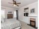 Large bedroom with fireplace, built-in shelving, and ceiling fan at 209 E Whitaker Mill Rd, Raleigh, NC 27608