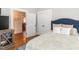 Guest bedroom with full bed and built-in closet at 209 E Whitaker Mill Rd, Raleigh, NC 27608