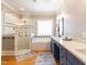 Spa-like bathroom with soaking tub, walk-in shower, and quartz countertops at 209 E Whitaker Mill Rd, Raleigh, NC 27608