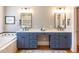 Elegant bathroom with dual vanities, soaking tub, and blue cabinetry at 209 E Whitaker Mill Rd, Raleigh, NC 27608