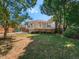 Large backyard with deck and mature trees providing shade at 209 E Whitaker Mill Rd, Raleigh, NC 27608