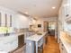 Spacious kitchen with island, stainless steel appliances, and white cabinetry at 209 E Whitaker Mill Rd, Raleigh, NC 27608