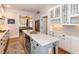 Kitchen with white cabinets, an island, and hardwood floors at 209 E Whitaker Mill Rd, Raleigh, NC 27608