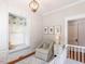 Bedroom with built-in storage and comfortable armchair at 209 E Whitaker Mill Rd, Raleigh, NC 27608