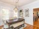 Bright dining room features a wood table, bench, and chandelier at 209 E Whitaker Mill Rd, Raleigh, NC 27608