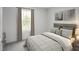 Well-lit bedroom with a striped comforter and wood headboard at 290 Gianna Dr, Lillington, NC 27546
