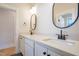Double vanity bathroom with modern fixtures and oval mirrors at 212 Meadow Walk Dr, Fuquay Varina, NC 27526