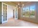 Bright office with hardwood floors, chandelier, and French doors at 212 Meadow Walk Dr, Fuquay Varina, NC 27526