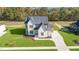 Two-story house with white brick and a gray roof, aerial view at 212 Meadow Walk Dr, Fuquay Varina, NC 27526