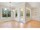 Bright dining room with hardwood floors and access to a screened porch at 212 Meadow Walk Dr, Fuquay Varina, NC 27526