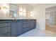 Modern bathroom with dark gray double vanity and marble floor at 212 Meadow Walk Dr, Fuquay Varina, NC 27526