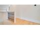 Upstairs hallway with light hardwood floors and iron railing at 212 Meadow Walk Dr, Fuquay Varina, NC 27526