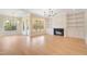 Bright living room with hardwood floors, fireplace, and built-in shelves at 212 Meadow Walk Dr, Fuquay Varina, NC 27526