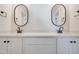 Double vanity bathroom with black framed mirrors and white cabinets at 212 Meadow Walk Dr, Fuquay Varina, NC 27526