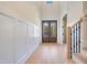 Bright entryway with hardwood floors, double doors, and elegant wainscoting at 212 Meadow Walk Dr, Fuquay Varina, NC 27526