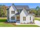 Two-story house with white brick and a gray roof at 212 Meadow Walk Dr, Fuquay Varina, NC 27526