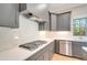 Modern kitchen features gas cooktop, white subway tile backsplash and stainless steel appliances at 212 Meadow Walk Dr, Fuquay Varina, NC 27526
