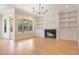 Bright living room with built-in shelving, fireplace, and hardwood floors at 212 Meadow Walk Dr, Fuquay Varina, NC 27526
