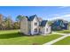 Two-story house with white brick and a gray roof, aerial view at 212 Meadow Walk Dr, Fuquay Varina, NC 27526