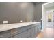 Stylish wet bar featuring a quartz countertop and modern gold fixtures at 212 Meadow Walk Dr, Fuquay Varina, NC 27526