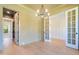 Bright office with hardwood floors, chandelier, and access to hallway at 212 Meadow Walk Dr, Fuquay Varina, NC 27526