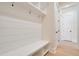 White shiplap-style mudroom with built-in bench and storage at 212 Meadow Walk Dr, Fuquay Varina, NC 27526