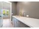 Wet bar with a quartz countertop, gray cabinetry, and gold faucet at 212 Meadow Walk Dr, Fuquay Varina, NC 27526