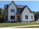 Two-story house with white brick and a gray roof at 212 Meadow Walk Dr, Fuquay Varina, NC 27526