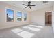 Spacious bedroom with three windows, ceiling fan, and carpet flooring at 212 Meadow Walk Dr, Fuquay Varina, NC 27526