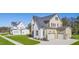 Two-story house with white brick and a gray roof, aerial view at 212 Meadow Walk Dr, Fuquay Varina, NC 27526