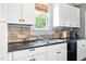 Modern kitchen sink and cabinets with granite countertop at 102 W Church St, Benson, NC 27504