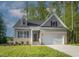 Brick home with gray siding, 2-car garage, and landscaped lawn at 902 Sw Maynard Rd, Cary, NC 27511