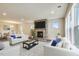Living room with stone fireplace and large windows at 902 Sw Maynard Rd, Cary, NC 27511