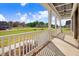 Covered front porch with white railing overlooking a landscaped neighborhood at 46 Otter Hole Dr, Princeton, NC 27569